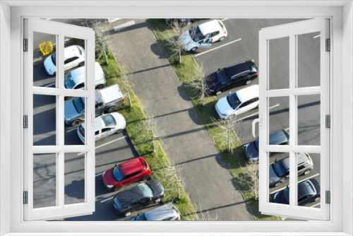 Fototapeta Naklejka Na Ścianę Okno 3D - Aerial view of many colorful cars parked on parking lot with lines and markings for parking places and directions
