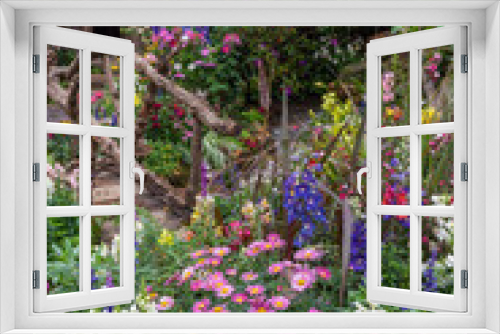 Fototapeta Naklejka Na Ścianę Okno 3D - Landscaped backyard flower garden of old house