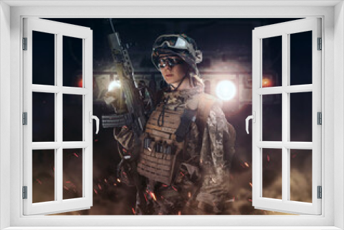 Fototapeta Naklejka Na Ścianę Okno 3D - Woman army soldier in combat uniforms with assault rifle, plate carrier, goggles and backpack. Studio shot in smoke, dark background