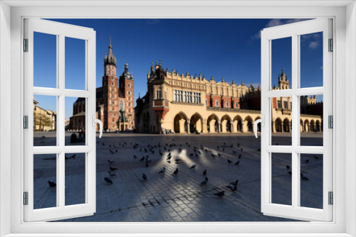 Fototapeta Naklejka Na Ścianę Okno 3D - The main square in Krakow with a view of the cloth hall and St. Mary's Basilica. Rynek główny w krakowie z widokiem na sukiennice i bazylikę mariacką.