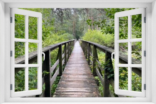Fototapeta Naklejka Na Ścianę Okno 3D - wooden footbridge passing through peat bog and swamp
