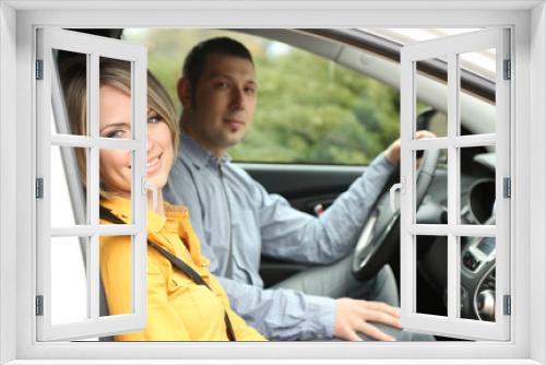 Portrait of young beautiful  couple sitting in the car