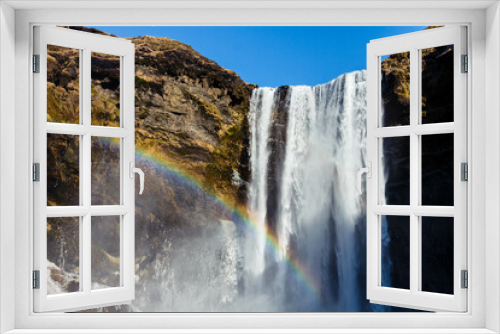 Fototapeta Naklejka Na Ścianę Okno 3D - Iceland waterfall travel nature famous tourist destination. Skogafoss waterfall with rainbow in magical landscape popular Europe attraction.
