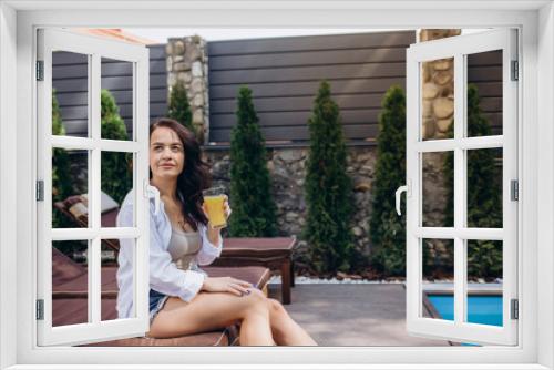 beautiful girl in sunglasses with fresh mango juice in luxury pool