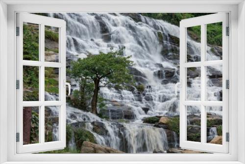 Fototapeta Naklejka Na Ścianę Okno 3D - The waterfall was flowing down from the rocky cliff. At Mae Ya Waterfall, Chom Thong District, Chiang Mai Province, Thailand