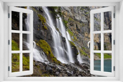 Fototapeta Naklejka Na Ścianę Okno 3D - Mystic waterfall at Lake Oeschinen in the Bernese Alps, Switzerland 