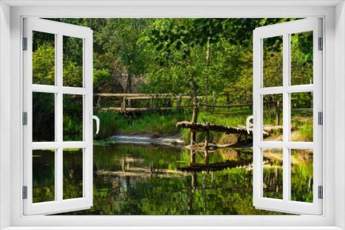 Fototapeta Naklejka Na Ścianę Okno 3D - Lake with a bridge. Cozy rest. Abandoned reservoir. Leisure time in nature. Bridge in the swamp