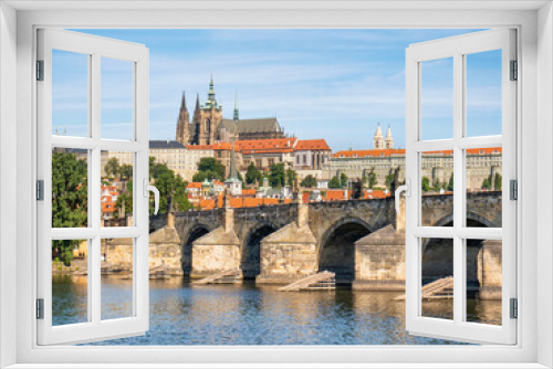 View with the Charles Bridge main touristic attraction with the Prague Castle in the background