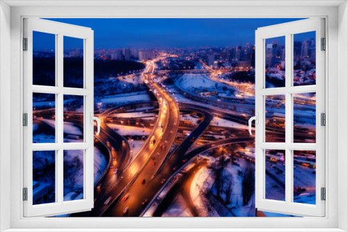 Fototapeta Naklejka Na Ścianę Okno 3D - Multi-level traffic interchange night winter drone view.