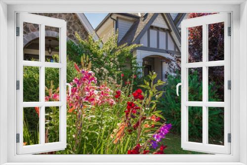 Fototapeta Naklejka Na Ścianę Okno 3D - Entrance to a home through a beautiful garden with colorful flowers. Plants and flowers in in a garden