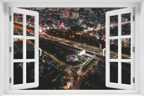 Fototapeta Naklejka Na Ścianę Okno 3D - Aerial view of a buildings with highway at night in Ho Chi Minh city, Vietnam