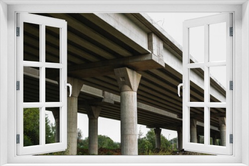 Fototapeta Naklejka Na Ścianę Okno 3D - Section of newly constructed elevated highway.Shot against a bright blue sky.