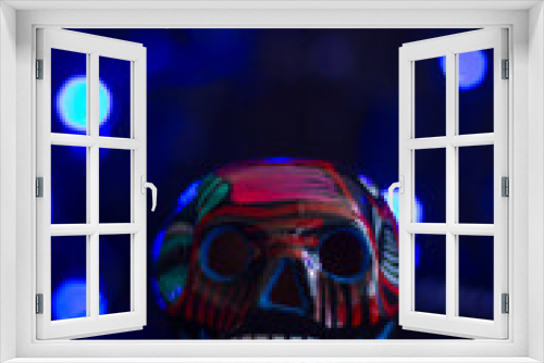 Fototapeta Naklejka Na Ścianę Okno 3D - Mexican dia de muertos ceramic skull on dark background with lights