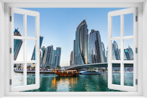 Fototapeta Naklejka Na Ścianę Okno 3D - Dubai marina and tourist boat at sunset.