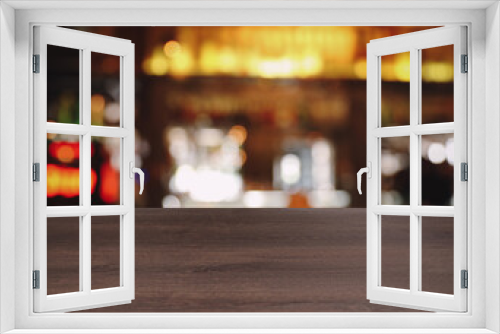 Empty wooden surface and blurred view of bar interior. Space for design