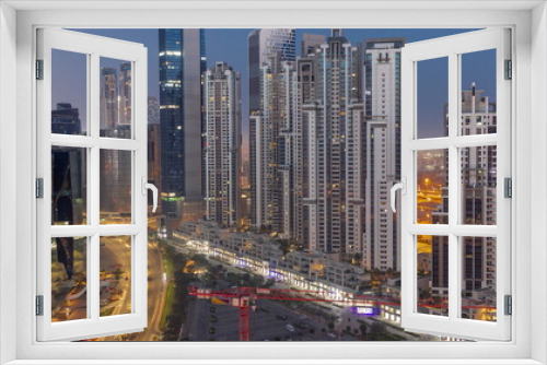 Fototapeta Naklejka Na Ścianę Okno 3D - Bay Avenue with modern towers residential development in Business Bay aerial night to day timelapse, Dubai
