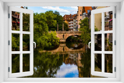Fototapeta Naklejka Na Ścianę Okno 3D - A bridge across the river between the houses