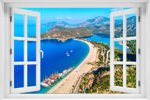 Fototapeta Naklejka Na Ścianę Okno 3D - Aerial view of mediterranean sea bay with mountain, sandy beach and boats at sunny day in summer. Drone photo of Blue lagoon in Oludeniz, Turkey