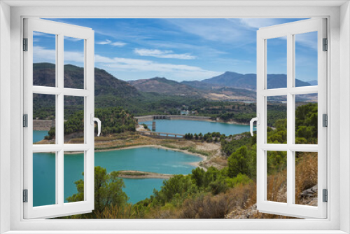 Fototapeta Naklejka Na Ścianę Okno 3D - Spectacular panoramic views of the Guadalhorce reservoir, next to the Caminito del Rey in Malaga, Spain. Turquoise blue water and forest with blue sky on a sunny day.
