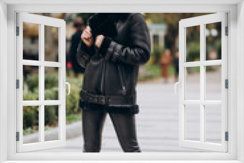 Young woman wearing jacket walking outside