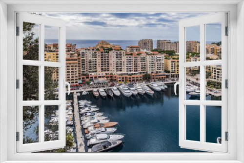 Fototapeta Naklejka Na Ścianę Okno 3D - Panoramic view of Fontvieille - district of Monaco with boats and a high-rise apartment complex. Principality of Monaco, French Riviera, Western Europe.