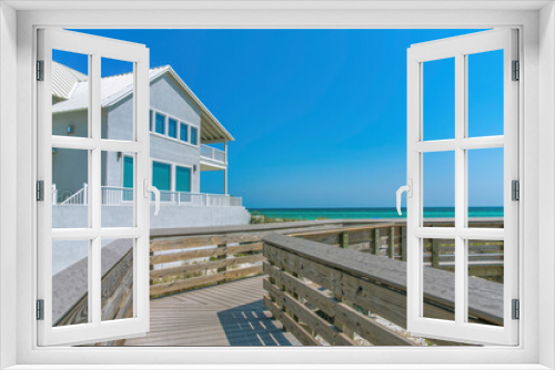 Fototapeta Naklejka Na Ścianę Okno 3D - Beach house view from a boardwalk on a beach at Destin, Florida