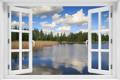 Fototapeta Naklejka Na Ścianę Okno 3D - Summer landscape in the lake water reflects the forest and the sky with clouds.