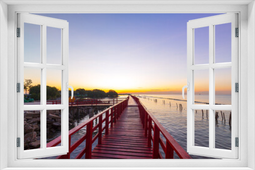 Fototapeta Naklejka Na Ścianę Okno 3D - red wooden bridge and sea in the morning,In the morning the red bridge and the sun rise on the horizon. Bridge over the sea in Thailand Thai landscape.