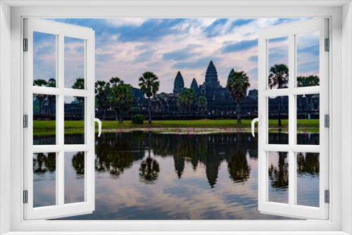 Fototapeta Naklejka Na Ścianę Okno 3D - Cambodia. Siem Reap Province. A silhouette of Angkor Wat (Temple City) and its reflection in the lake at early morning.  A Buddhist and temple complex in Cambodia and the largest religious monument in