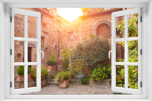 Fototapeta Naklejka Na Ścianę Okno 3D - Picturesque building in medieval town in Tuscany, Italy. Old stone walls and plants