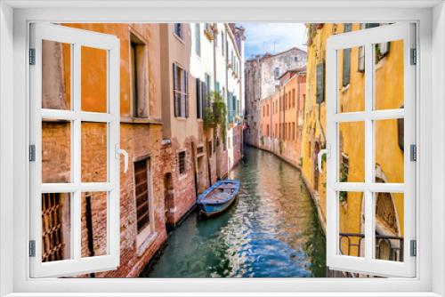 Fototapeta Naklejka Na Ścianę Okno 3D - Venice, Italy - July 5, 2022: Building exteriors, boats and gondolas along the canals in Venice Italy
