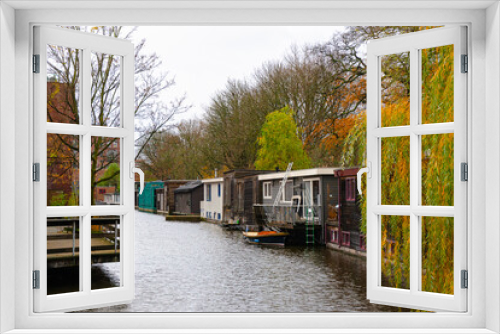 Fototapeta Naklejka Na Ścianę Okno 3D - Houseboats near The Eastern gate and towers in Delft ,   during autumn , winter : Delft , Netherlands : November 28 , 2019