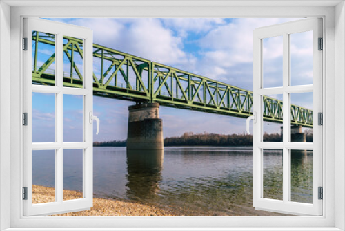 Fototapeta Naklejka Na Ścianę Okno 3D - a green railroad bridge over a river