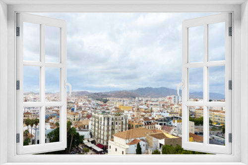 Fototapeta Naklejka Na Ścianę Okno 3D - high angle view of the city from Alcazaba de Malaga on a cloudy day. one of the most famous attractions in Malaga, Spain. High quality photo