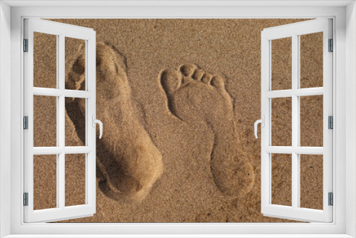 Fototapeta Naklejka Na Ścianę Okno 3D - Male and female footprint on sand