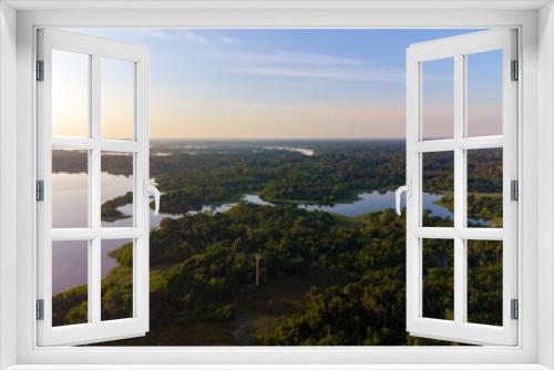 Fototapeta Naklejka Na Ścianę Okno 3D - Aerial view of Igapó, the Amazon rainforest in Brazil, an incredible green landscape with lots of water and untouched nature at sunset time