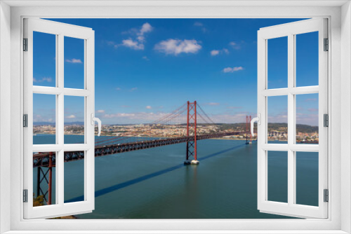 Fototapeta Naklejka Na Ścianę Okno 3D - The 25 de Abril Bridge (Ponte 25 de Abril) is a suspension bridge connecting the city of Lisbon capital of Portugal, to the municipality of Almada on the left (south) bank of the Tagus river.