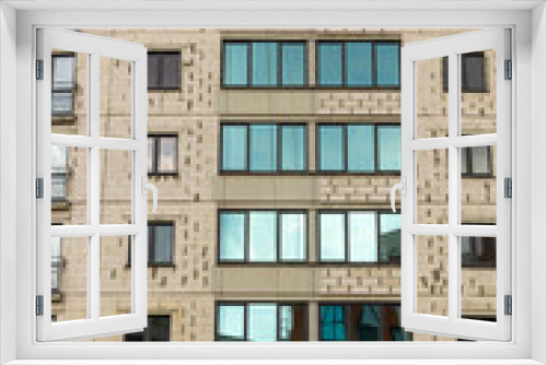 Fototapeta Naklejka Na Ścianę Okno 3D - The process of insulating external walls in a multi-storey building under construction.