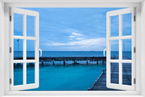 Fototapeta Naklejka Na Ścianę Okno 3D - View of the pier and the ocean on a resort island in the Maldives