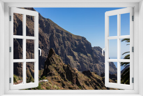 Fototapeta Naklejka Na Ścianę Okno 3D - Sharp pinnacle in centre of remote tourist village Masca in the Teno mountain range, Tenerife, Canary islands, Spain, Europe. Rock formation is surrounded by steep cliffs. Gulch connceted to the sea