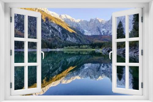 Fototapeta Naklejka Na Ścianę Okno 3D - Reflection of forest and mountains in Lake Superiore in Fusine in autumn at sunset on the Julian Alps, Italy