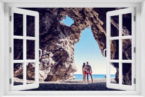 Fototapeta Naklejka Na Ścianę Okno 3D - Kobieta i mężczyzna przytuleni w jaskini z widokiem na morze
