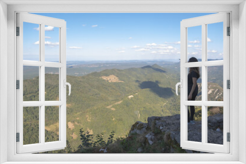 Fototapeta Naklejka Na Ścianę Okno 3D - Young woman pointing to the horizon from the ruines of the Montsegur castle in France. Achievement concept