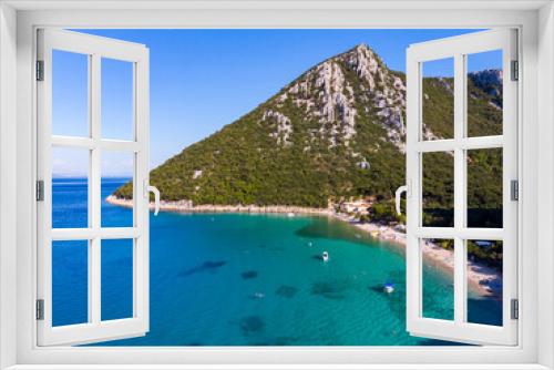 Fototapeta Naklejka Na Ścianę Okno 3D - aerial view of a paradisiacal Mediterranean bay with turquoise water surrounded by massive mountains, with floating motorboats, with a small bushy island; the bay on the peljesac peninsula seen from a