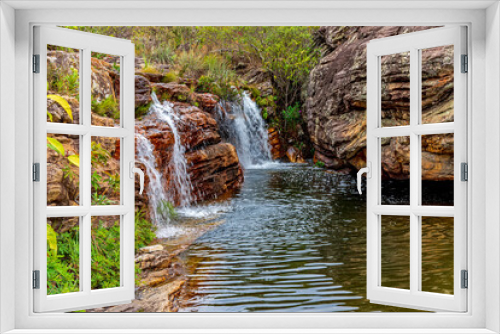 Fototapeta Naklejka Na Ścianę Okno 3D - Beautiful and small waterfall among the rocks and vegetation of the Biribiri environmental reserve in Diamantina, Minas Gerais.