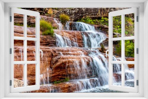 Fototapeta Naklejka Na Ścianę Okno 3D - Water blur on beautiful and small waterfall among the rocks and vegetation of the Biribiri environmental reserve in Diamantina, Minas Gerais.