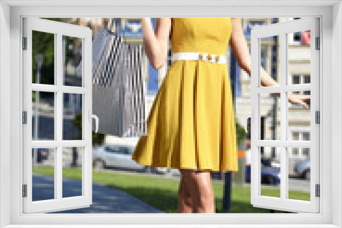 fashionable girl in yellow dress with shopping bag a old city st