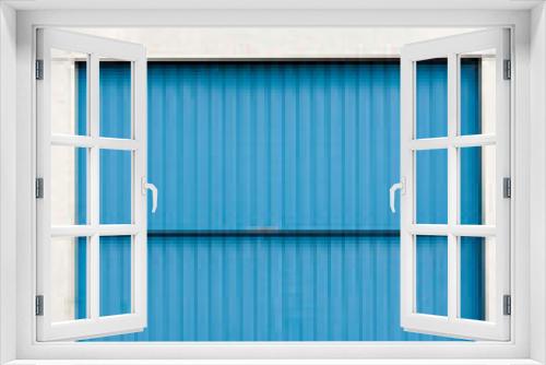 Fototapeta Naklejka Na Ścianę Okno 3D - Puerta metálica azul en nave industrial de hormigón 