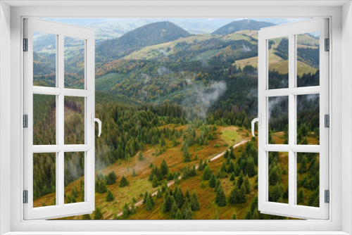 Fototapeta Naklejka Na Ścianę Okno 3D - Panorama of forest covered by low clouds. Autumn rain and fog on the mountain hills. Misty fall woodland.
