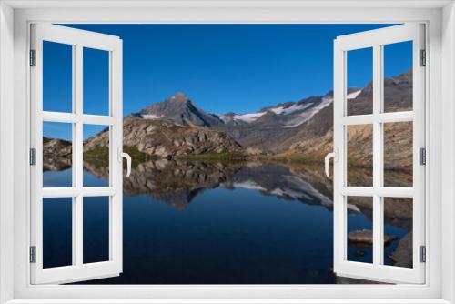 Fototapeta Naklejka Na Ścianę Okno 3D - the peaceful waters of the white lake facing the majestic summit of the Dent Parrachee in the heart of the French Alps